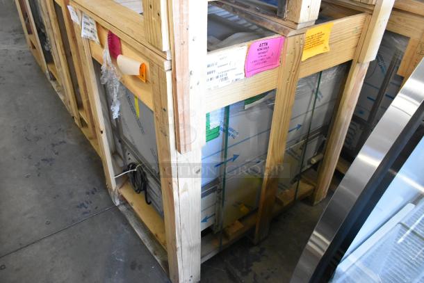 BKI 52473-1 stainless steel commercial freezer in crate. Brand new, 115V, 1 phase, with casters. Labels visible on crate.