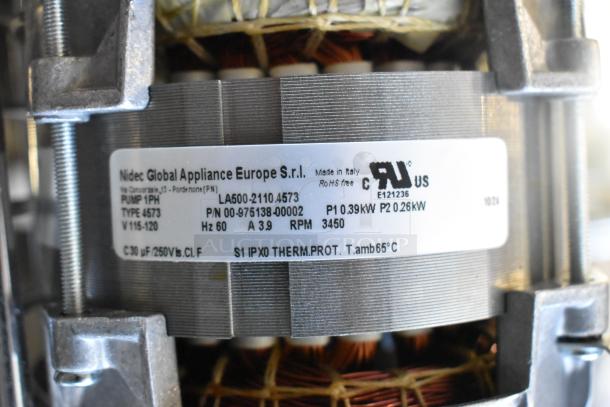 Nidec pump, 115 volts, 1 phase, model 4573, new with scratches and dents. Label shows specifications and manufacturing details.