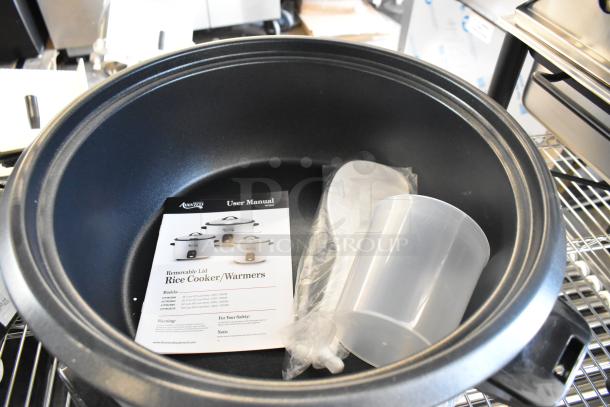 Brand new Avantco 177RCB60 rice cooker, 60 cup capacity, includes user manual, measuring cup, and paddle, 120V, 1 phase.