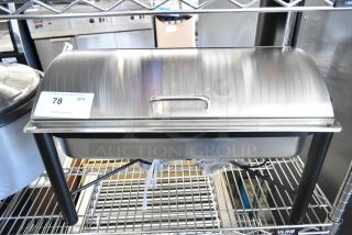 Brand new scratch and dent stainless steel chafer, with slight imperfections, displayed on a metal rack.