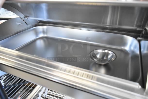 Brand new stainless steel chafer with minor scratches and dents, open lid view, includes base and food pan.