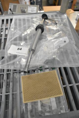 Brand new scratch and dent items including server eco pump and grate, sealed in packaging with auction label visible.