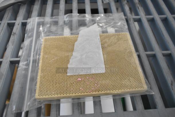 Brand new server eco pump grate, rectangular with perforated design, in sealed plastic bag on metal grate surface.
