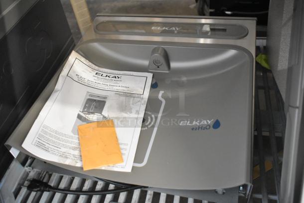 Brand new Elkay EZSDWS_1G wall mount water fountain with bottle filling attachment. Scratch and dent condition. Instruction manual visible.
