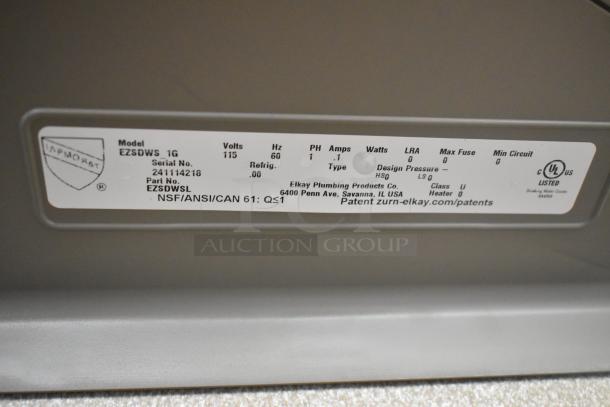 Label on Elkay EZSDWS_1G metal wall mount water fountain. Shows model, voltage, and compliance details. Brand new, scratch and dent condition.