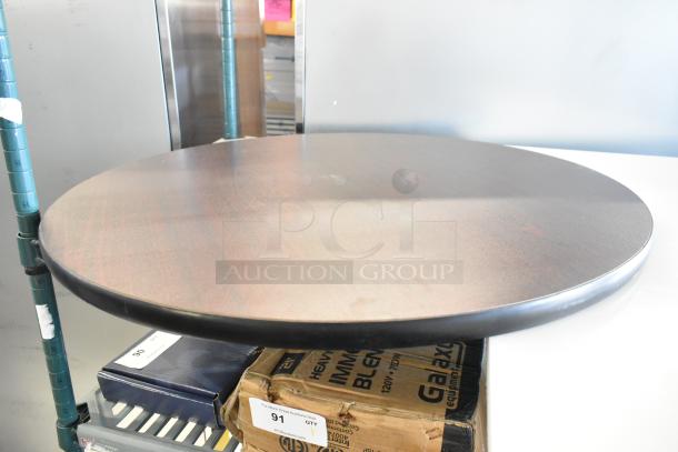 Brand new black round tabletop with slight scratches and dents, sturdy build. Ideal for dining or office use.