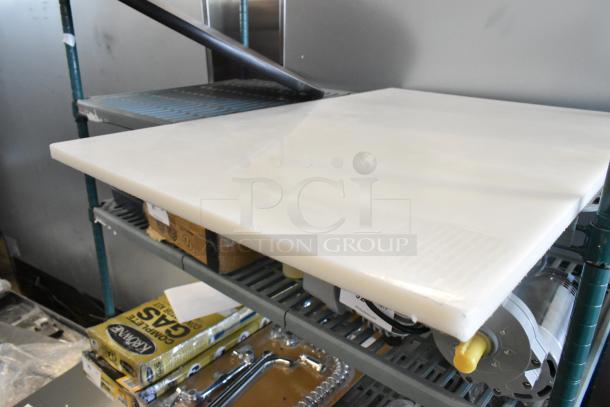 Brand new white cutting board, scratch and dent condition, on a shelf. Durable and practical for kitchen use.