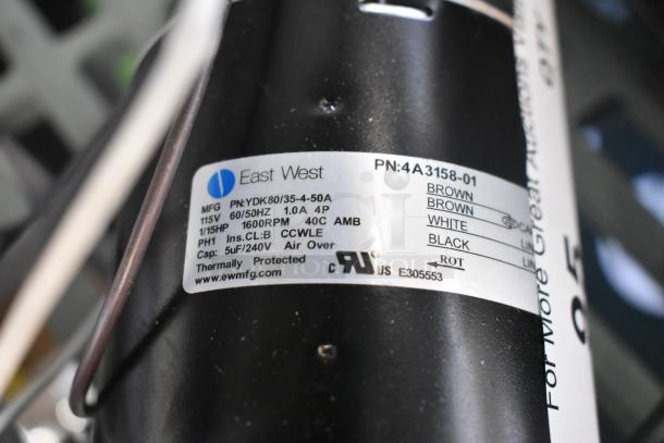 Brand new East West YDK80/35-4-50A motor, 115V, 1 Phase, 1600RPM. Scratch and dent condition. Thermal protection label visible.