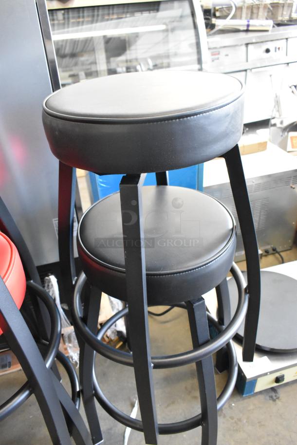 Eight new black metal stools with red and black seat cushions; minor scratches and dents visible.