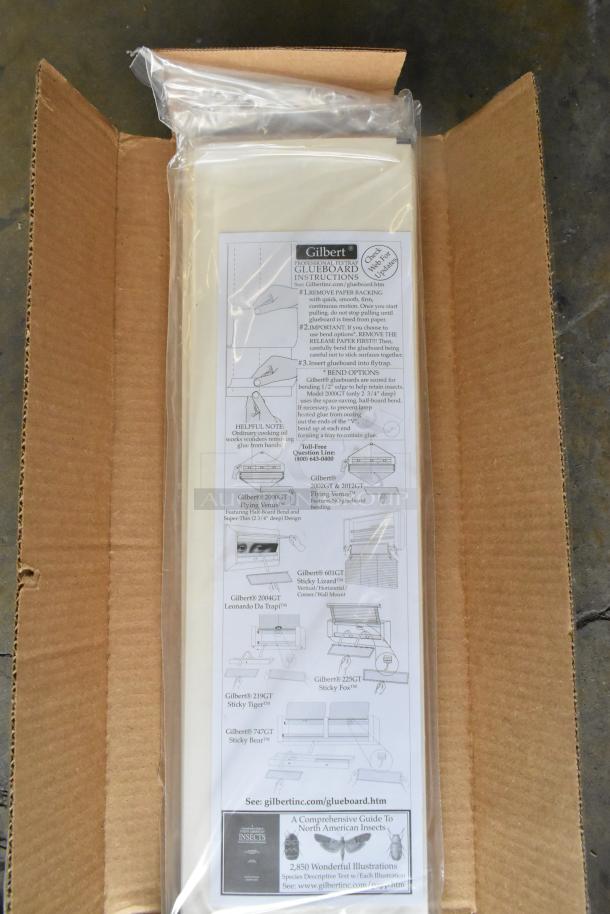 6 unopened boxes of Gilbert 10226042 5"x17" Glueboard. "Scratch and Dent" condition, detailed instructions visible.