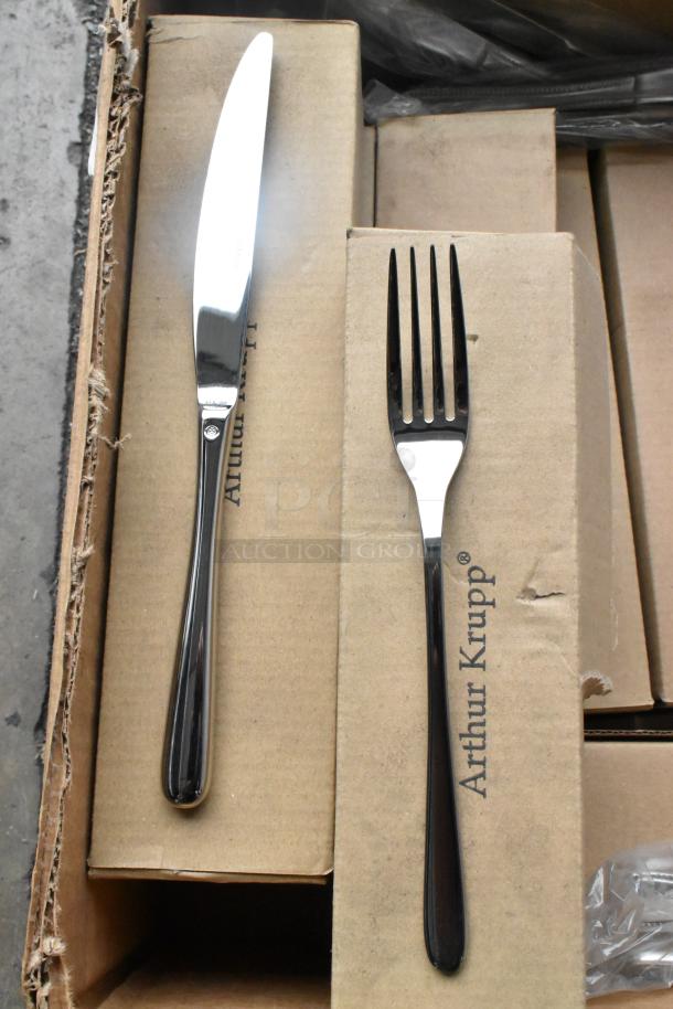 Brand new Arthur Krupp forks and knives in original packaging. Visible branding on boxes. Condition: Scratch and dent.