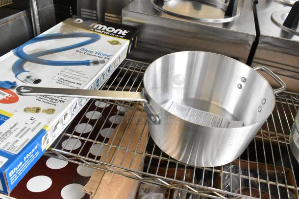 Brand new Winco ASP-10 aluminum 10 qt saucepan with solid metal handle; scratch and dent condition, visible label inside.