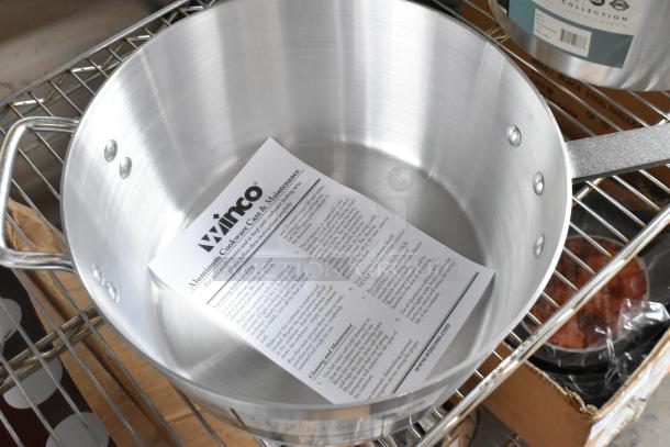 8 brand new Winco ASP-10 10 qt aluminum saucepans with solid metal handles, slight scratches, included care instructions.