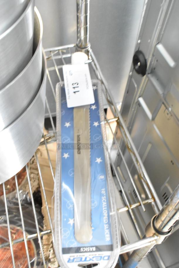 BRAND NEW Dexter 10" Scalloped Slicer Knife in packaging, minor scratches, marked as scratch and dent, displayed on shelf.