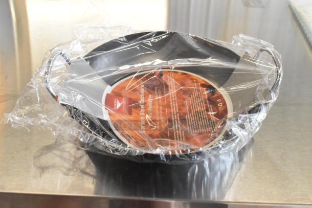 Box of 12 brand new Vollrath 9.5" 10149300 paella pans, scratch and dent condition, wrapped in clear packaging, carbon steel.