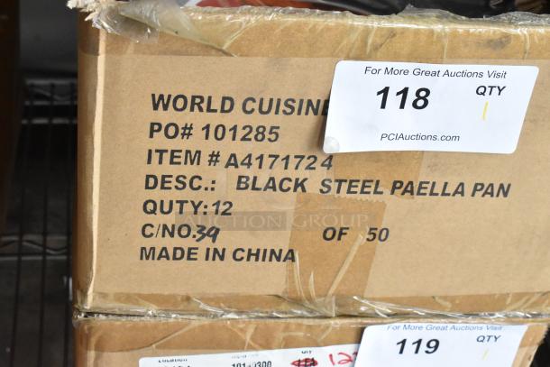 Box of 12 brand new scratch and dent Vollrath 9.5" black steel paella pans. Item #A4171724, Made in China, visible packaging labels.