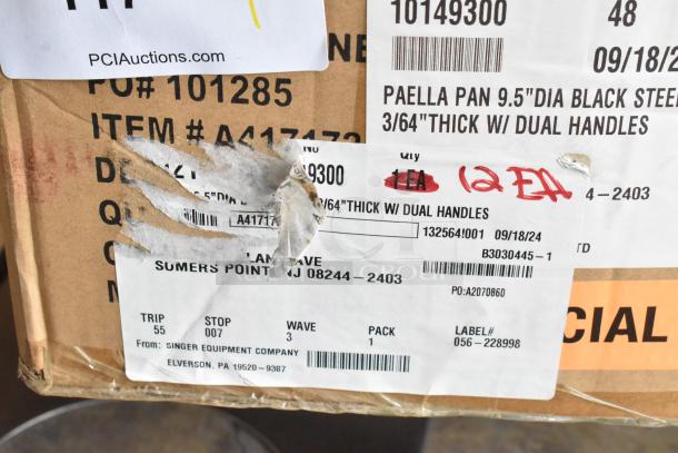 Box of 12 brand new Vollrath 9.5" paella pans, model 10149300, scratch and dent condition, with labels and markings.