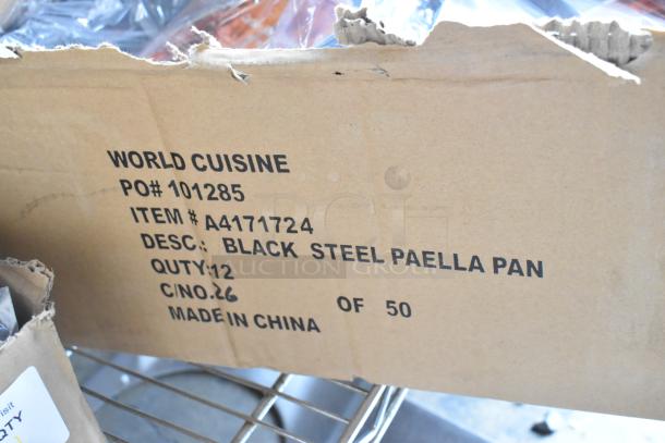 Box of 12 Vollrath 9.5" black steel paella pans, scratch and dent condition, PO# 101285, item #A4171724, made in China.