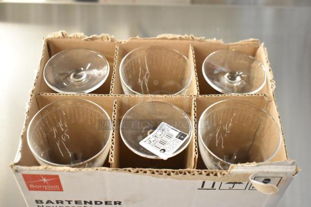 10 new boxes of 6 Bormioli Rocco Bartender Nick & Nora glasses, scratch and dent condition, boxed with labels visible.