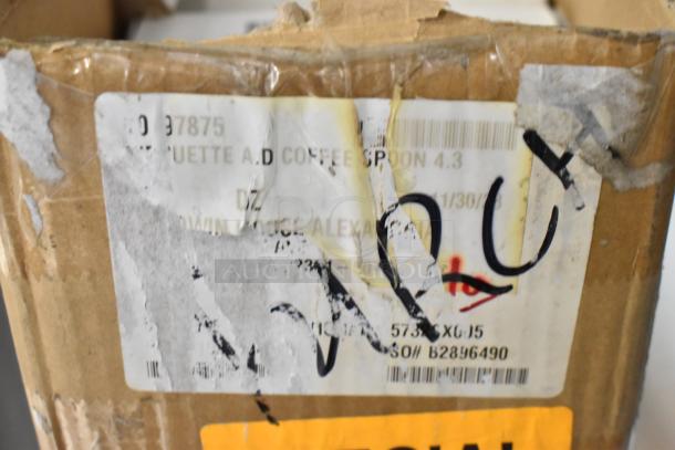 Close-up of a worn shipping label on a cardboard box containing Steelite 5732SX005 coffee spoons, marked "special."
