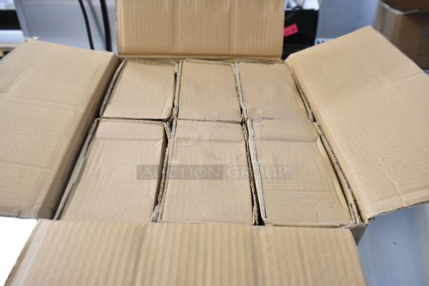 Open cardboard box containing brand new scratch and dent items: white poly bowls, Steelite coffee spoons, ITI white plates.