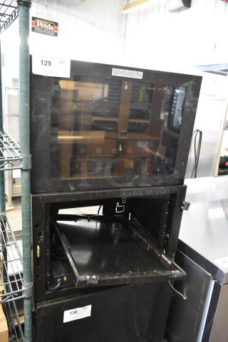 Two Great Lakes black metal cabinets, one missing a pane. Some signs of wear. Labels indicate Great Lakes brand.