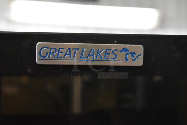 Two black Great Lakes metal cabinets, one missing a pane. "Great Lakes" label shown. Auction doubles your bid.