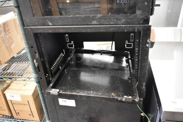Two Great Lakes black metal cabinets, one missing pane, in used condition. Includes adjustable shelves. Auction lot number 130.