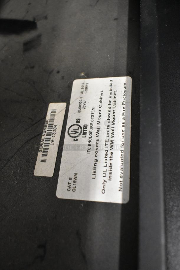 Label on black metal Great Lakes cabinet, model GL15WM, ITC Enclosure System, UL listed. One pane missing.