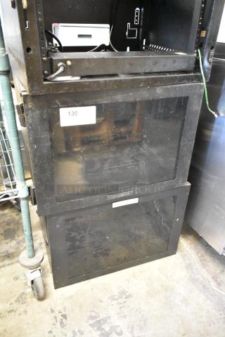 2 Great Lakes black metal cabinets, visible wear, glass doors, labeled '130', sturdy construction, ideal for storage or organizing.