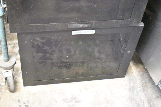 Great Lakes black metal cabinet, sturdy construction, minor wear, visible logo, ideal for storage solutions. Two available.