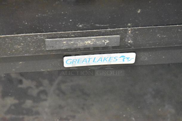 Great Lakes black metal cabinet with visible logo; durable design, suitable for storage. Mild wear noted on surface.