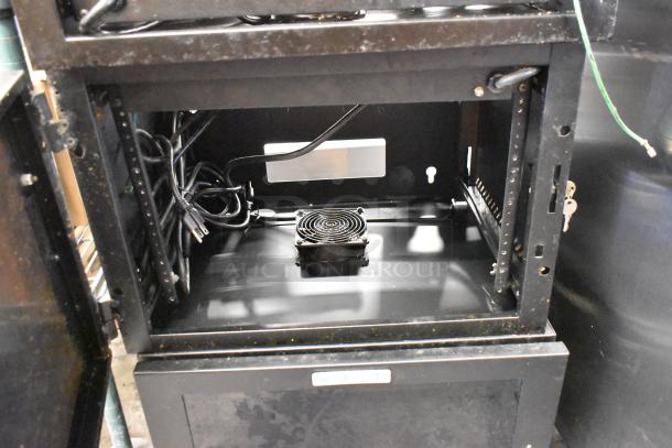 Two Great Lakes black metal cabinets, showing the interior wiring and a mounted fan. Cabinets in used condition with visible wear.