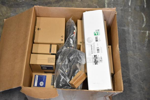 Open box with various new items including Tripp Lite N252-048 Rack Mount and other electronics, labeled packages visible.