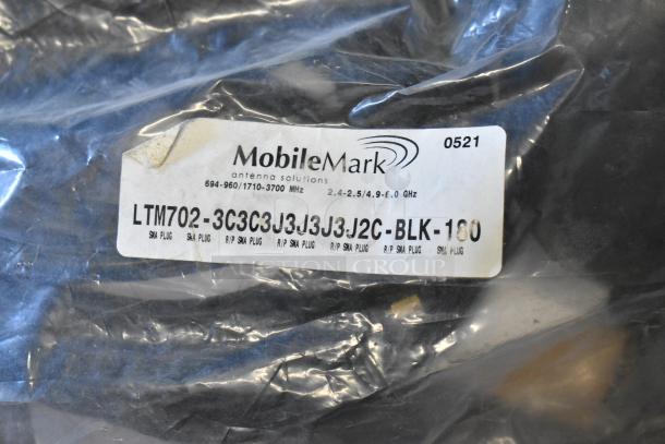 Mobile Mark LTM702-3C3C3J3J3J3J2C-BLK-180 antenna in original packaging. Visible label detailing frequency range and SMA plug type.