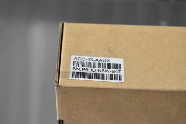 Cardboard box with a label showing "ACC-IG-AAUX" and serial number "SN:P6UD-N6W-B4T", part of Samsara scratch and dent lot.