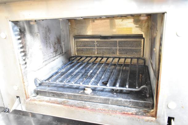 Merrychef eikon e4 stainless steel commercial rapid cook oven, electric, shows interior with grill, in used condition.