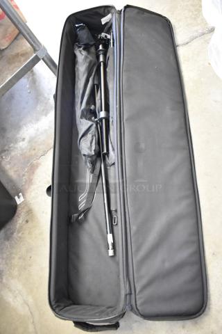 Soft case containing a tripod. Black fabric exterior, zipper closure, appears in good condition.