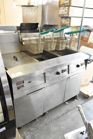 Frymaster FM245ESC Stainless Steel Commercial Floor Style Natural Gas Powered 2 Bay Deep Fat Fryer w/ Filtration System, Dumping Station and 4 Metal Fry Baskets on Commercial Casters. 105,000 BTU. - Item #1204410