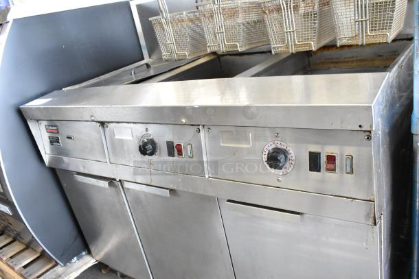 Frymaster FM245ESC stainless steel 2-bay deep fat fryer with filtration, dumping station, and 4 fry baskets on casters. 105,000 BTU.