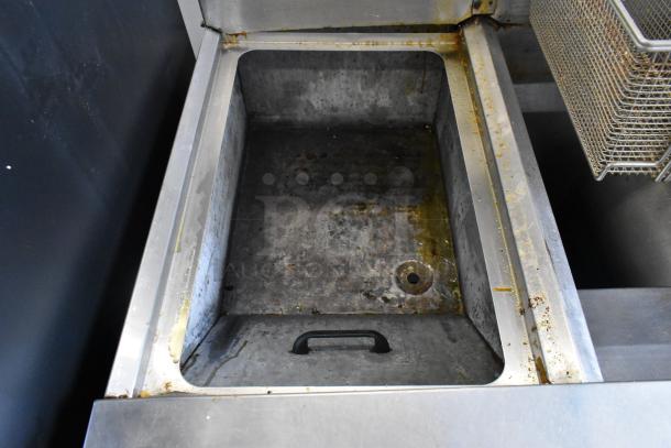 Frymaster FM245ESC stainless steel 2 bay deep fat fryer with filtration system, dumping station, and 4 baskets. Shows interior condition.