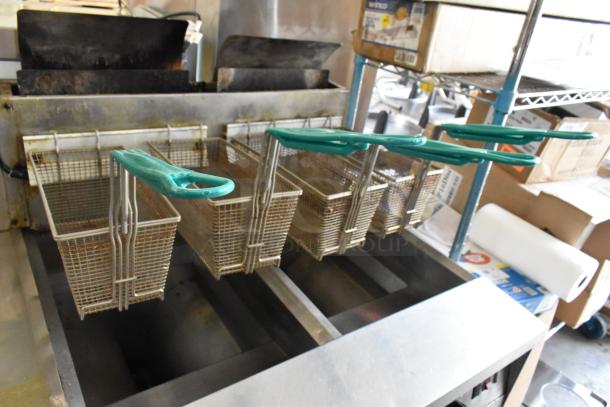 Frymaster FM245ESC stainless steel commercial fryer, 2-bay, natural gas, with filtration, dumping station, 4 metal baskets.