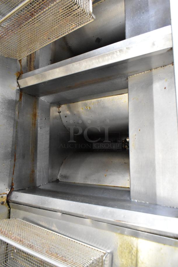 Frymaster FM245ESC stainless steel 2-bay deep fat fryer, with filtration system, visible fry baskets, and commercial casters. 105,000 BTU.