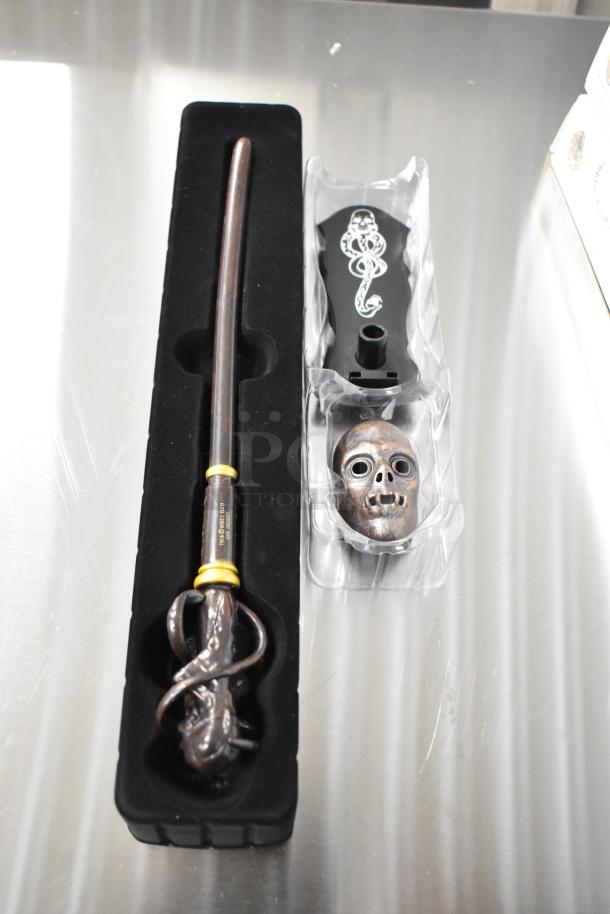 Set of 8 Harry Potter wands in display boxes, including Death Eater wand with skull stand. New condition.