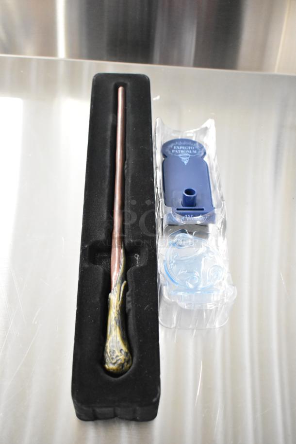 Harry Potter Ron Weasley wand in black display case, detailed grip, includes "Expecto Patronum" base, excellent condition.