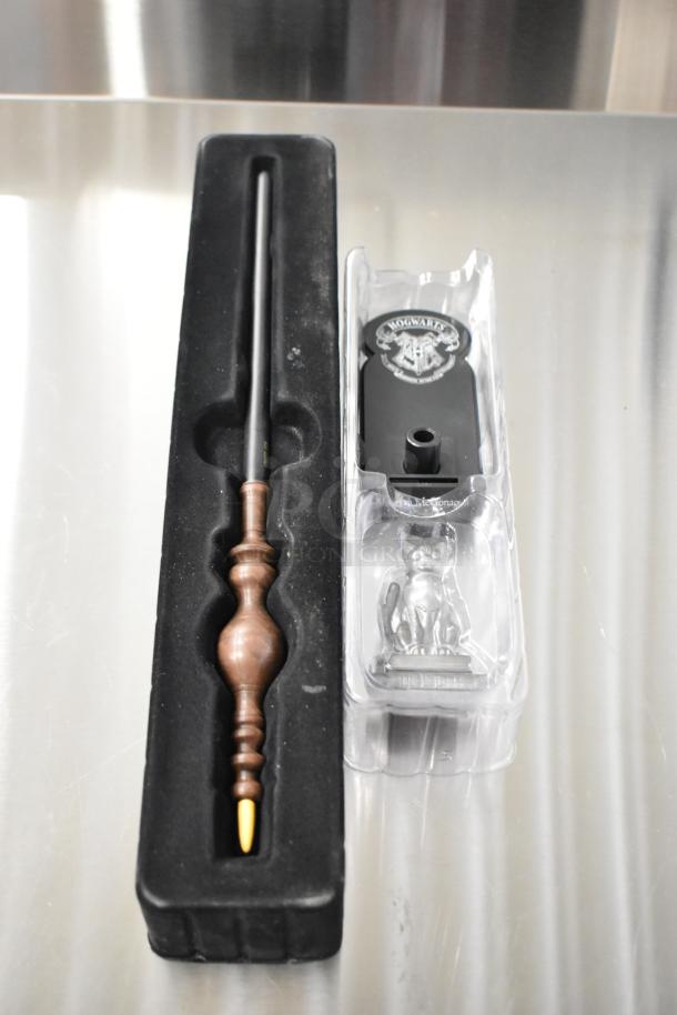 Harry Potter wand in a black case with a display stand and Hogwarts emblem. Condition appears excellent.