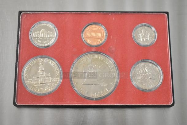 United States Proof Coin Set featuring years 1968, 1969, 1975-1976, 1980. Coins in mint condition, red display case.