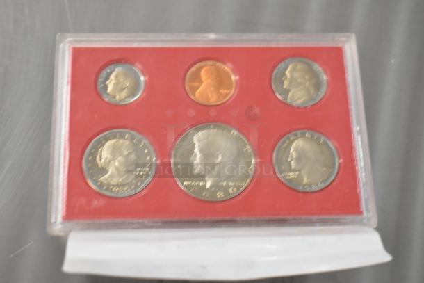 Four U.S. Proof Coin Sets dating 1968, 1969, 1975-1976, and 1980 in mint condition, housed in protective cases.