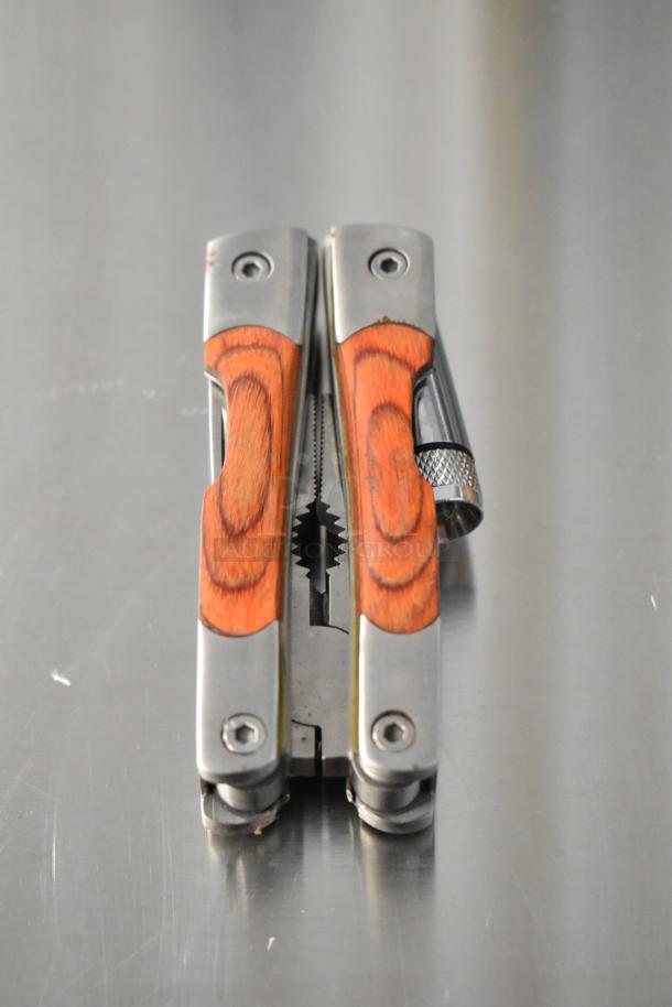 5 pocket knives including Schrade 1520T, CRKT R2301, Camillus 440, wood handles, stainless steel, excellent condition.