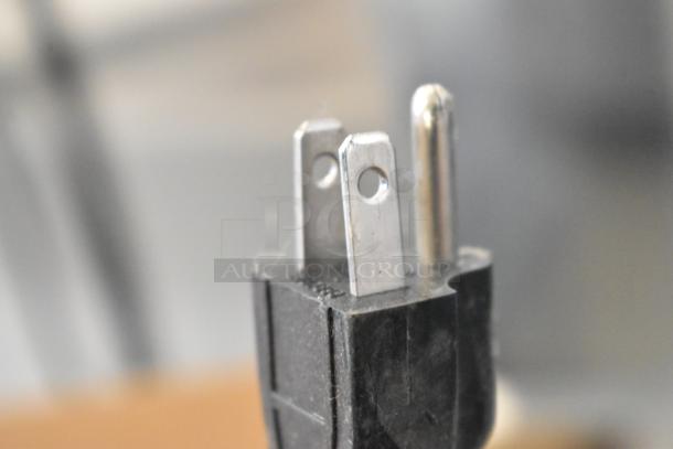 Close-up of a power plug for a Lancer LFS Stainless Steel Fryer, 115 volts, 1 phase, showing metal prongs.